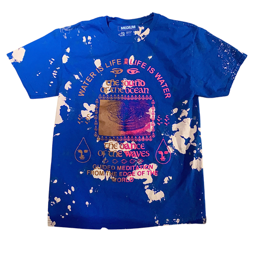 A royal blue t shirt with an abstract bleached effect. The t-shirt reads 